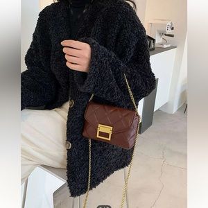 Chestnut quilted crossbody bag with gold chain.